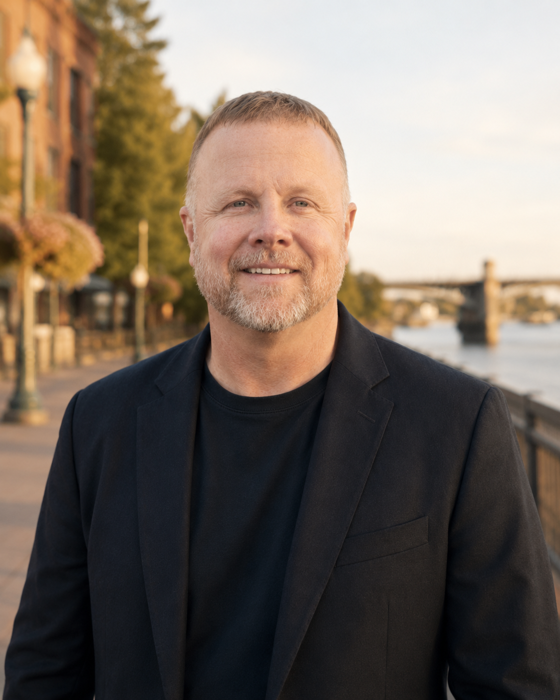 Editorial portrait of Jason Cadwell along the Willamette riverfront in Albany, Oregon at golden hour.
